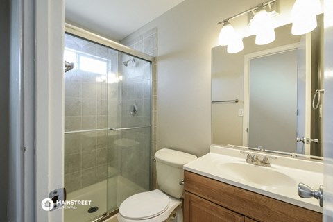 a bathroom with a shower toilet and sink