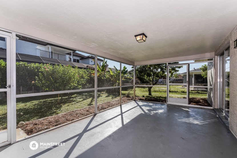 a large patio with glass doors and a backyard