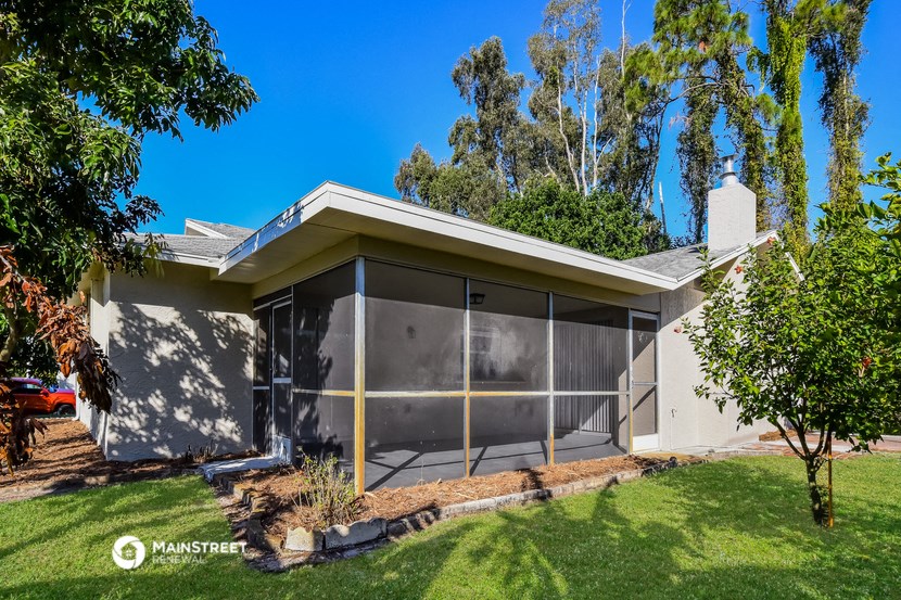 a house with a garage and a lawn and trees