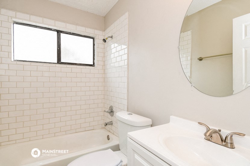 a bathroom with a sink and a toilet and a bath tub