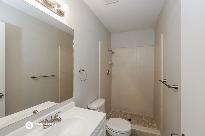 a bathroom with a sink and a toilet and a shower