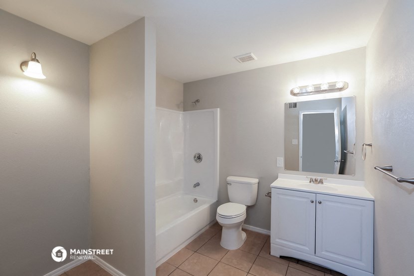 a bathroom with a shower toilet and sink and a mirror