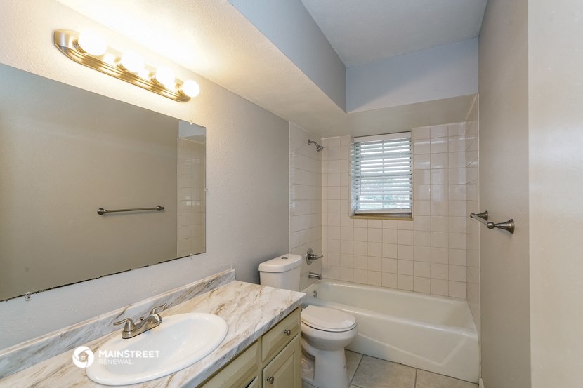 a bathroom with a sink and a toilet and a tub