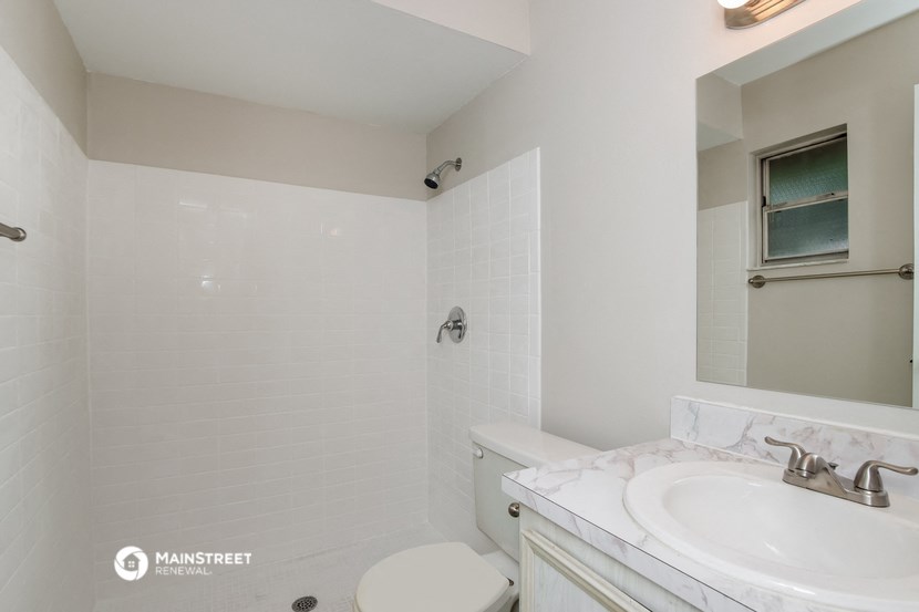 a white bathroom with a sink and a toilet