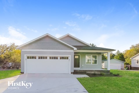 a home with a driveway and a white garage door