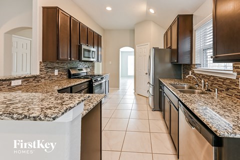 a modern kitchen with granite counter tops and stainless steel appliances
