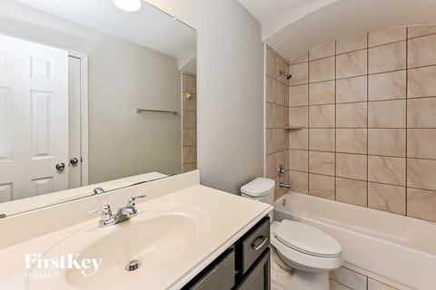 a bathroom with a sink and a toilet and a tub