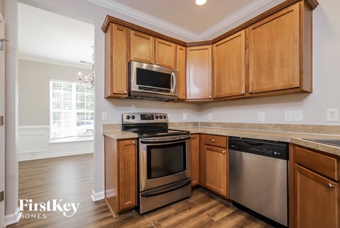 A kitchen with wooden cabinets and stainless steel appliances.