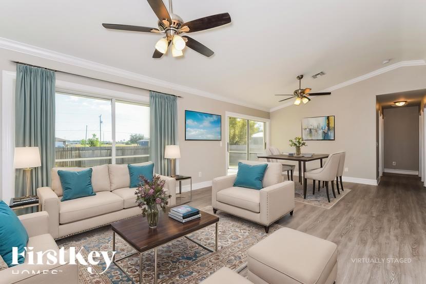 A living room with a couch, chairs, and a coffee table.
