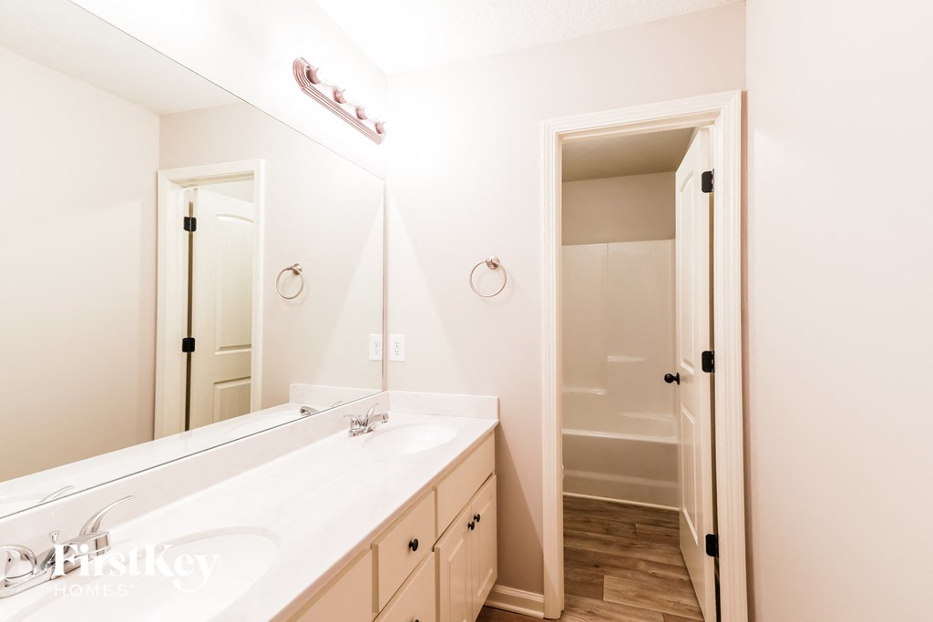 a bathroom with two sinks and a large mirror