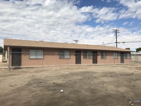 a building with a chain link fence in front of it