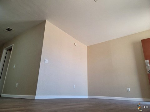 an empty room with a wall and a door