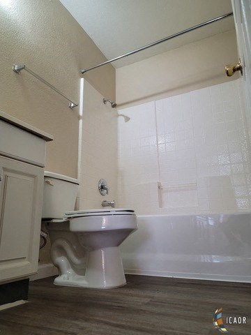 a bathroom with a toilet and a bath tub