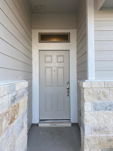 the front door of a home with a light above it