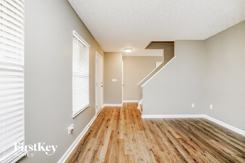 the living room and dining room with hardwood flooring