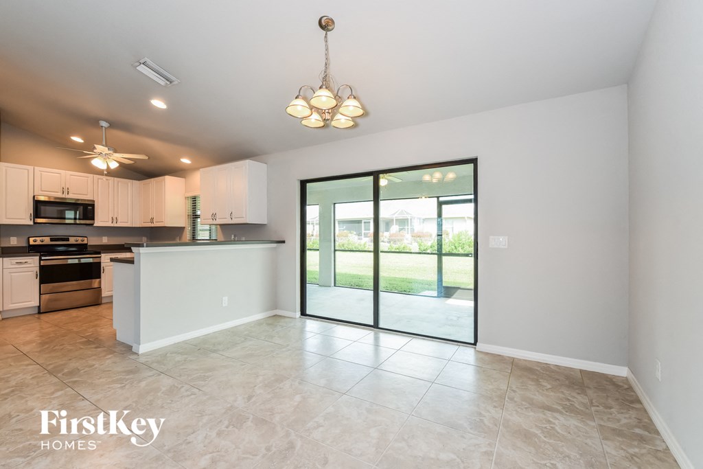 A spacious kitchen with a view of the backyard through the sliding glass doors.