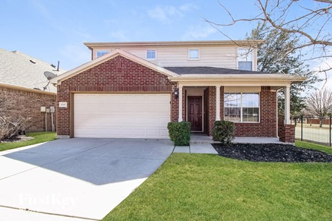 A house with a brick facade and a white garage door.
