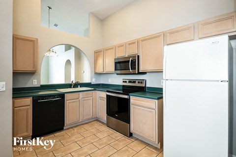a kitchen with wooden cabinets and a white refrigerator