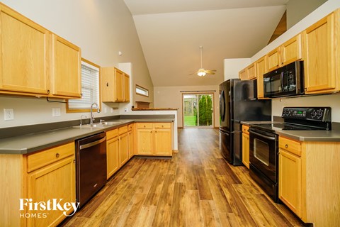 a kitchen with black appliances and wooden cabinets