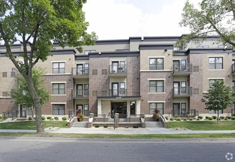 Apartment buildings with trees in front of them.