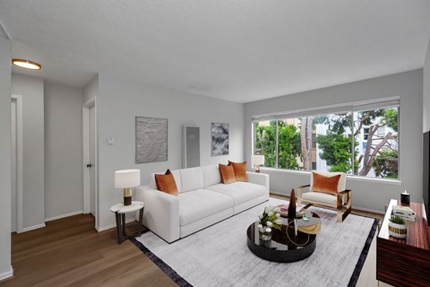 A living room with a white couch and a coffee table.