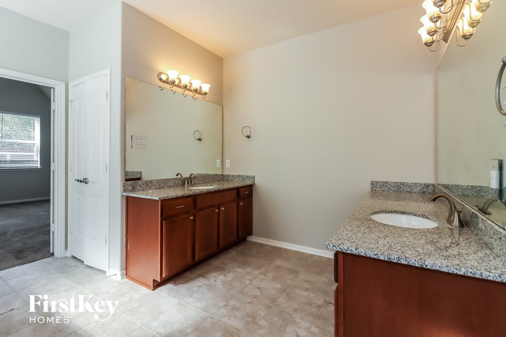 a bathroom with granite counter tops and a sink and a mirror