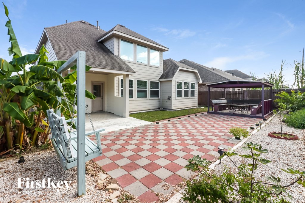 a backyard with a patio and a house