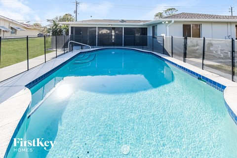A swimming pool with a FirstKey Homes logo.