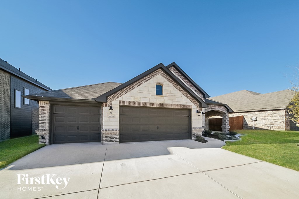 a single story home with a garage and a driveway