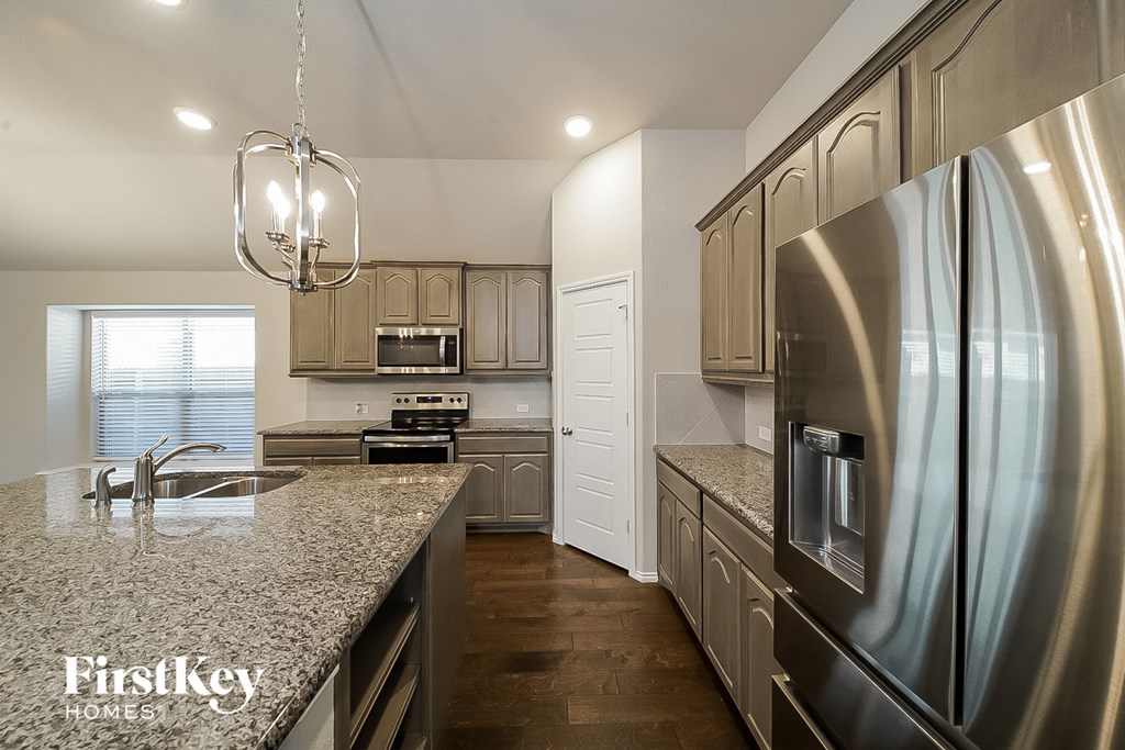a kitchen with stainless steel appliances and granite counter tops