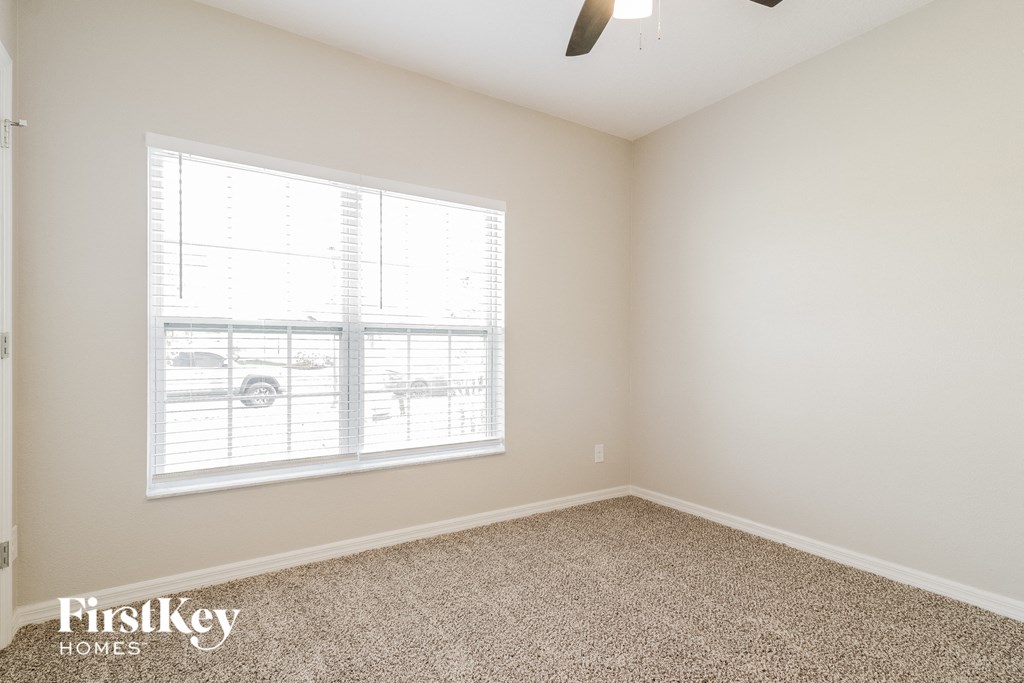 A room with a car parked outside the window.