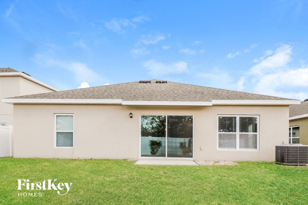 A house with a clear blue sky and a logo of FirstKey Homes on the bottom left.