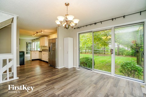 the living room and kitchen of a house with large sliding glass doors
