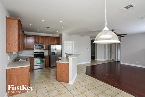 a kitchen with wooden cabinets and stainless steel appliances