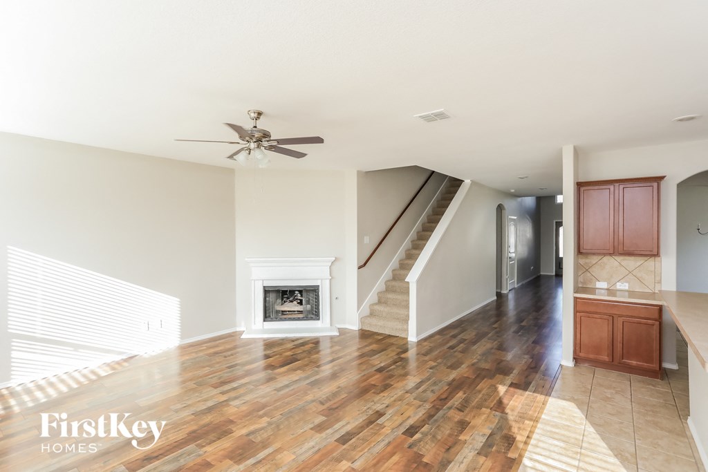 a living room with a hard wood floor and a fireplace