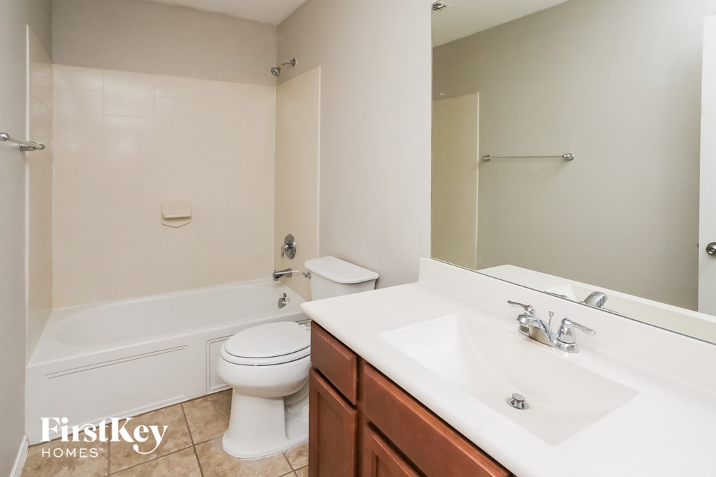 a bathroom with a sink toilet and a bath tub