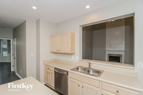 A kitchen with a sink and a dishwasher.