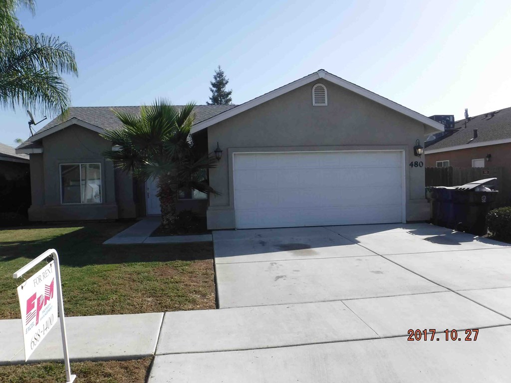 a home with a driveway and a garage door