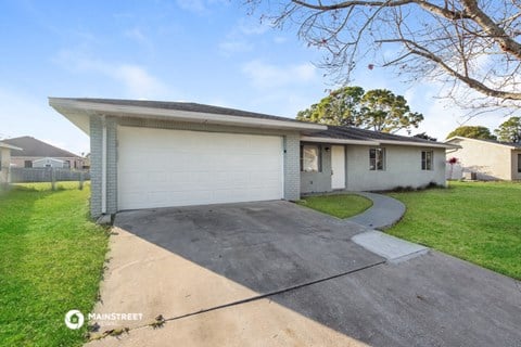 a white house with a driveway and a white garage door