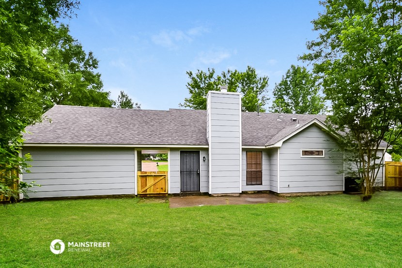 a white house with a garage and a green lawn
