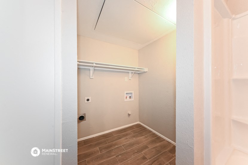 a empty room with a white wall and a white closet