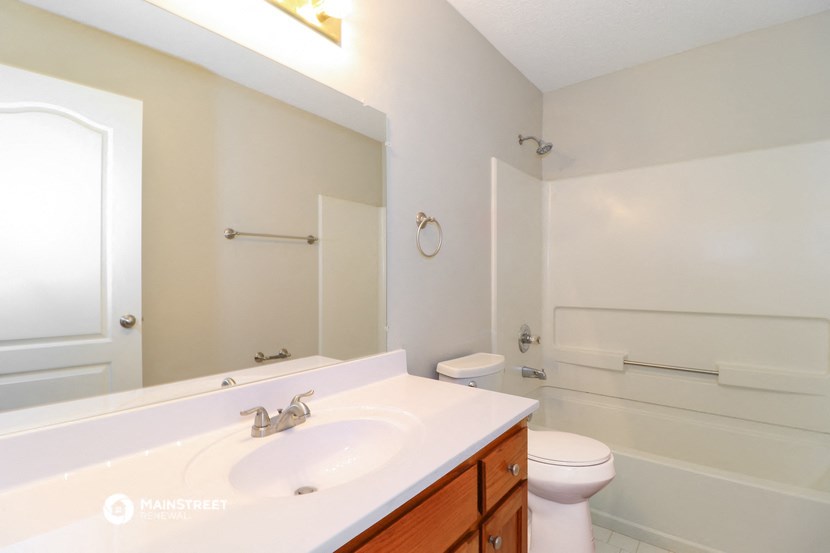 a bathroom with a sink and a toilet and a mirror