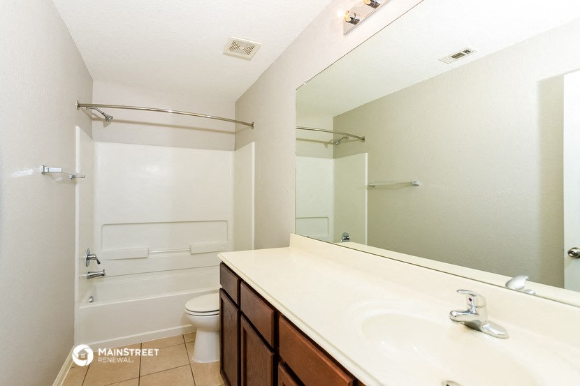 a bathroom with a sink and a shower and a toilet