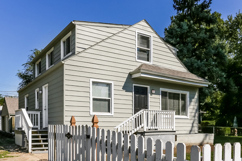 a house with a white fence in front of it