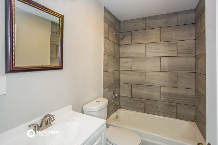 a bathroom with a shower toilet and sink and a bath tub