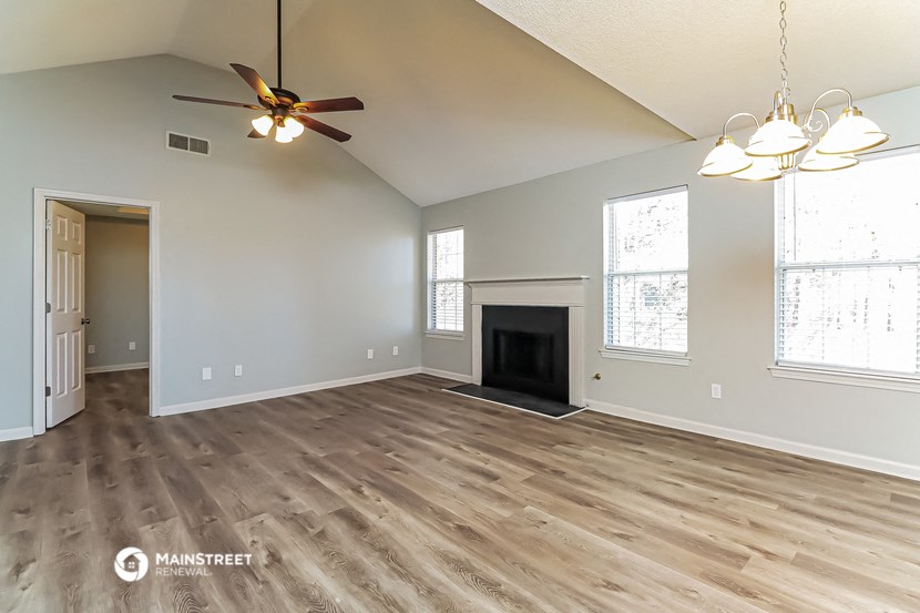 the living room has a fireplace and hardwood floors