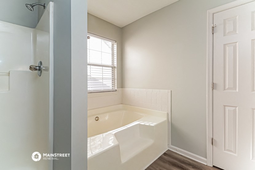 a bathroom with a large tub and a window