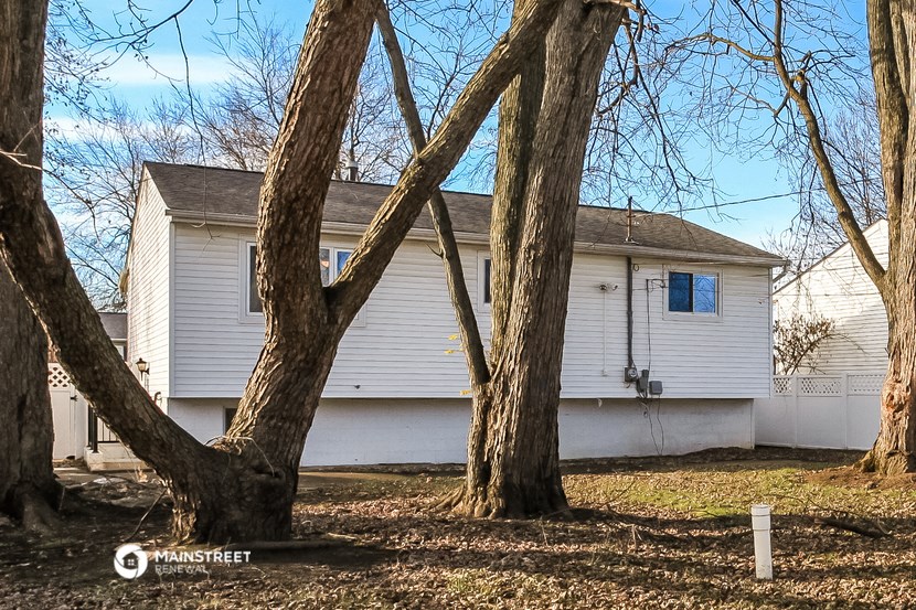 a white house with trees in front of it