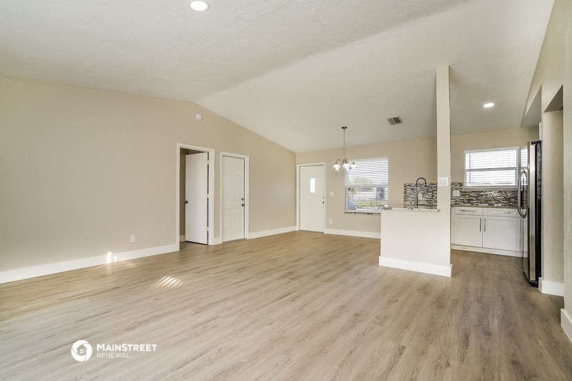 the living room and kitchen of an open floor plan