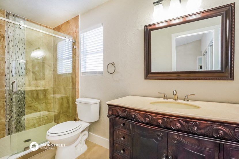 a bathroom with a sink toilet and a shower